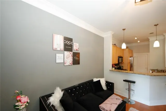 a living room with furniture and a mirror