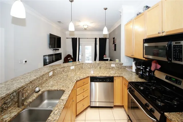 a large kitchen with granite countertop a stove and a sink