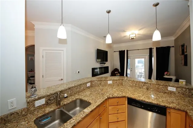 a view of a kitchen with a sink and a chandelier