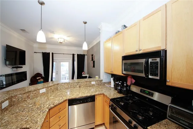 a kitchen with stainless steel appliances granite countertop a stove and a microwave