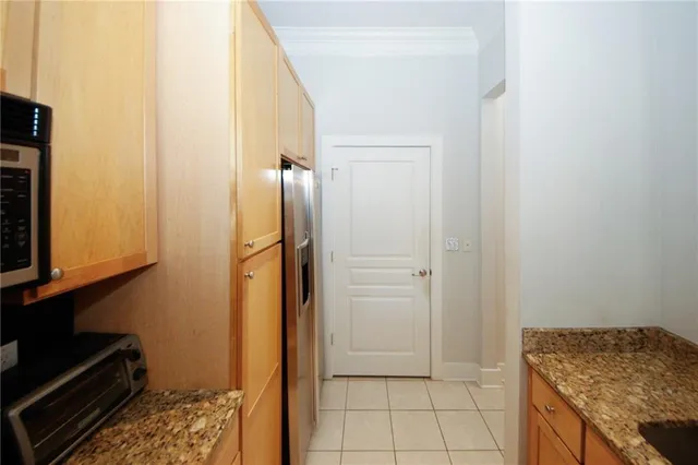 a bathroom with a granite countertop sink and a washing machine
