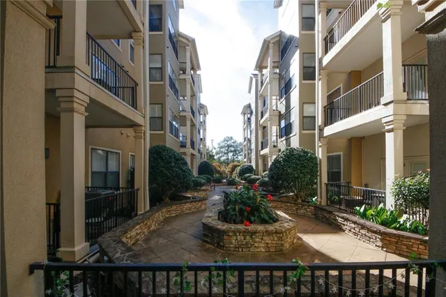 a backyard of a house with barbeque oven and outdoor seating