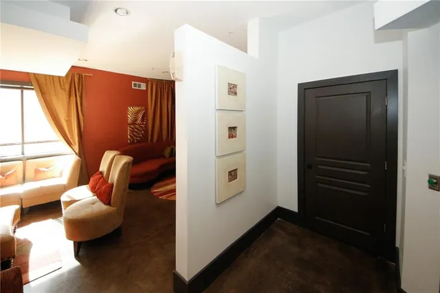 a view of hallway with furniture and a window