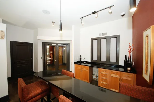 a kitchen with granite countertop sink table and chairs