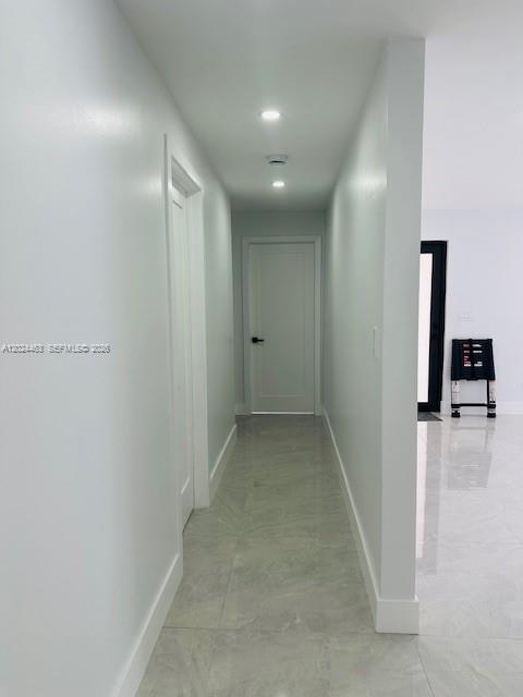 11870 Southwest 5th Street, Unit 1 Miami, FL 33184 - Photo 28 of 38 a view of a hallway to a room with wooden floor