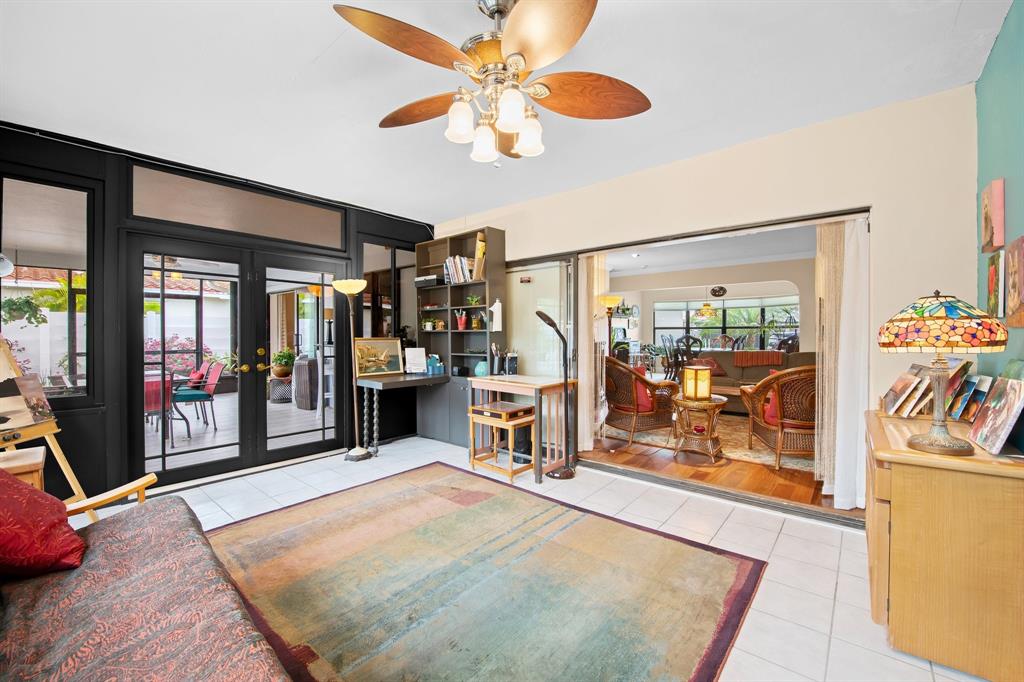 4700 Grant Street Hollywood, FL 33021 - Photo 13 of 32 a living room with furniture a flat screen tv and a floor to ceiling window