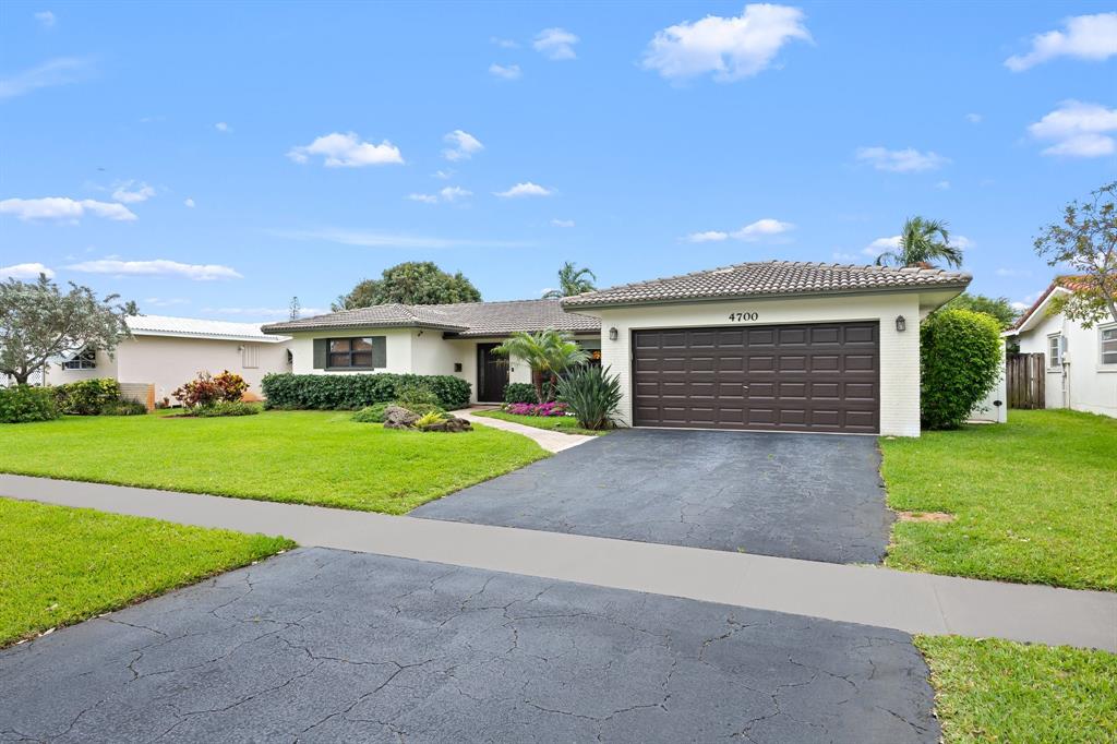 4700 Grant Street Hollywood, FL 33021 - Photo 31 of 32 a front view of a house with a yard and garage