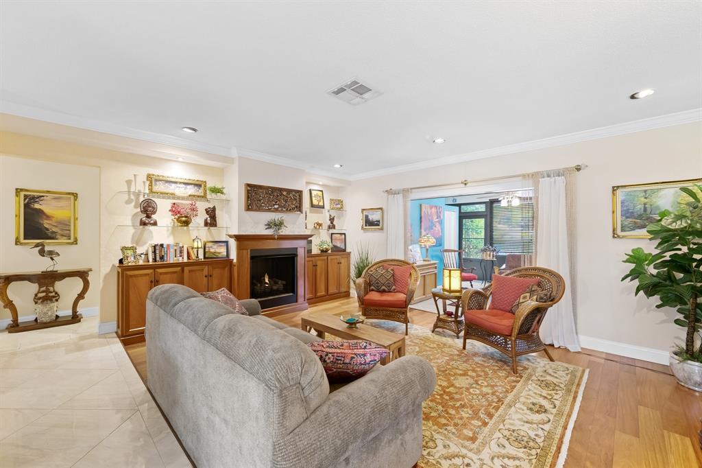 4700 Grant Street Hollywood, FL 33021 - Photo 4 of 32 a living room with furniture a fireplace and potted plants