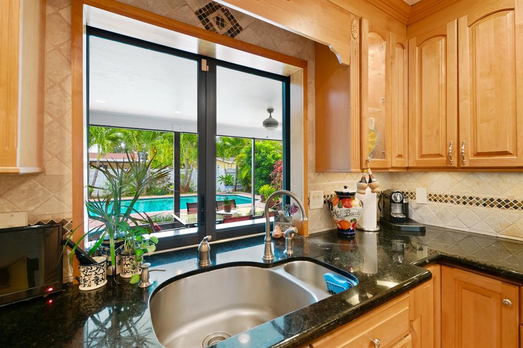 4700 Grant Street Hollywood, FL 33021 - Photo 8 of 32 a kitchen with a sink a counter top space and a refrigerator