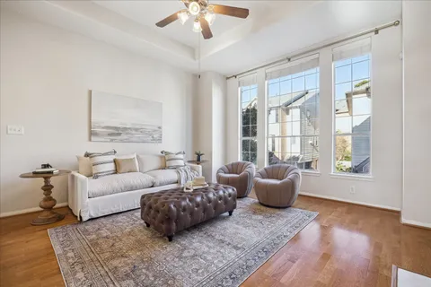 a bedroom with a large bed and a chandelier fan