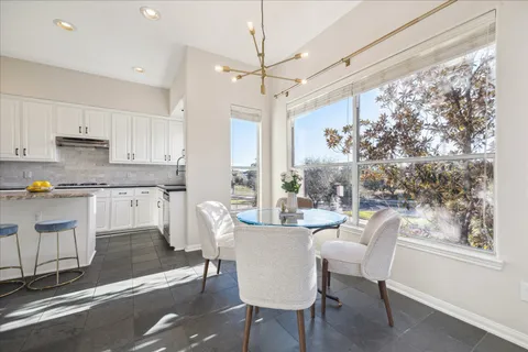 a kitchen with stainless steel appliances granite countertop a sink stove and cabinets
