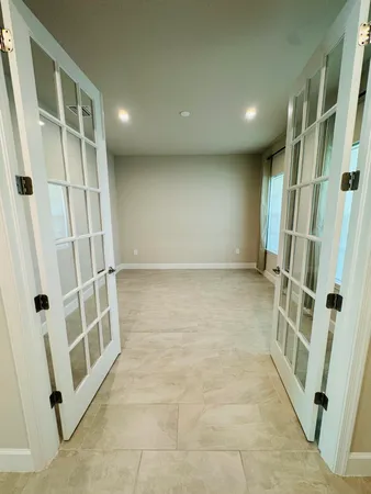 a large kitchen with granite countertop a large counter top stainless steel appliances and cabinets