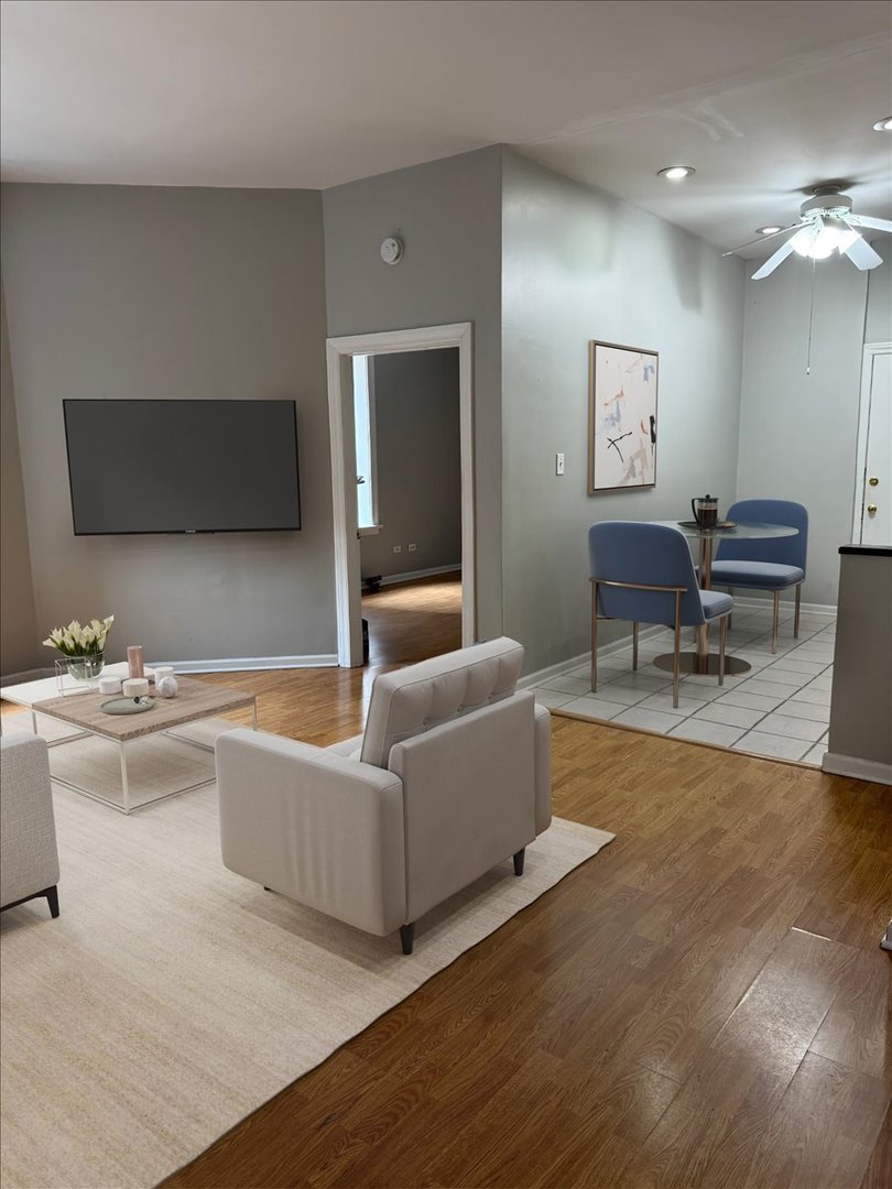 20 East Goethe Street, Unit 203 Chicago, IL 60610 - Photo 2 of 9 a living room with furniture and a flat screen tv