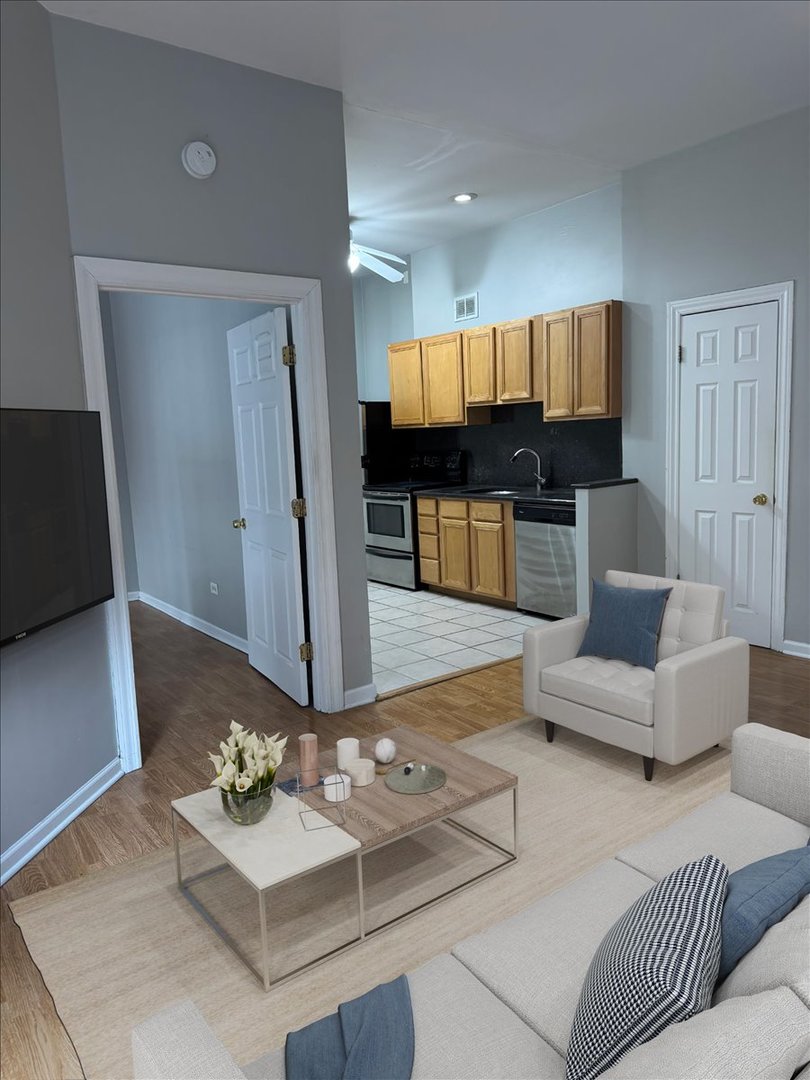 20 East Goethe Street, Unit 203 Chicago, IL 60610 - Photo 5 of 9 a living room with furniture and a flat screen tv