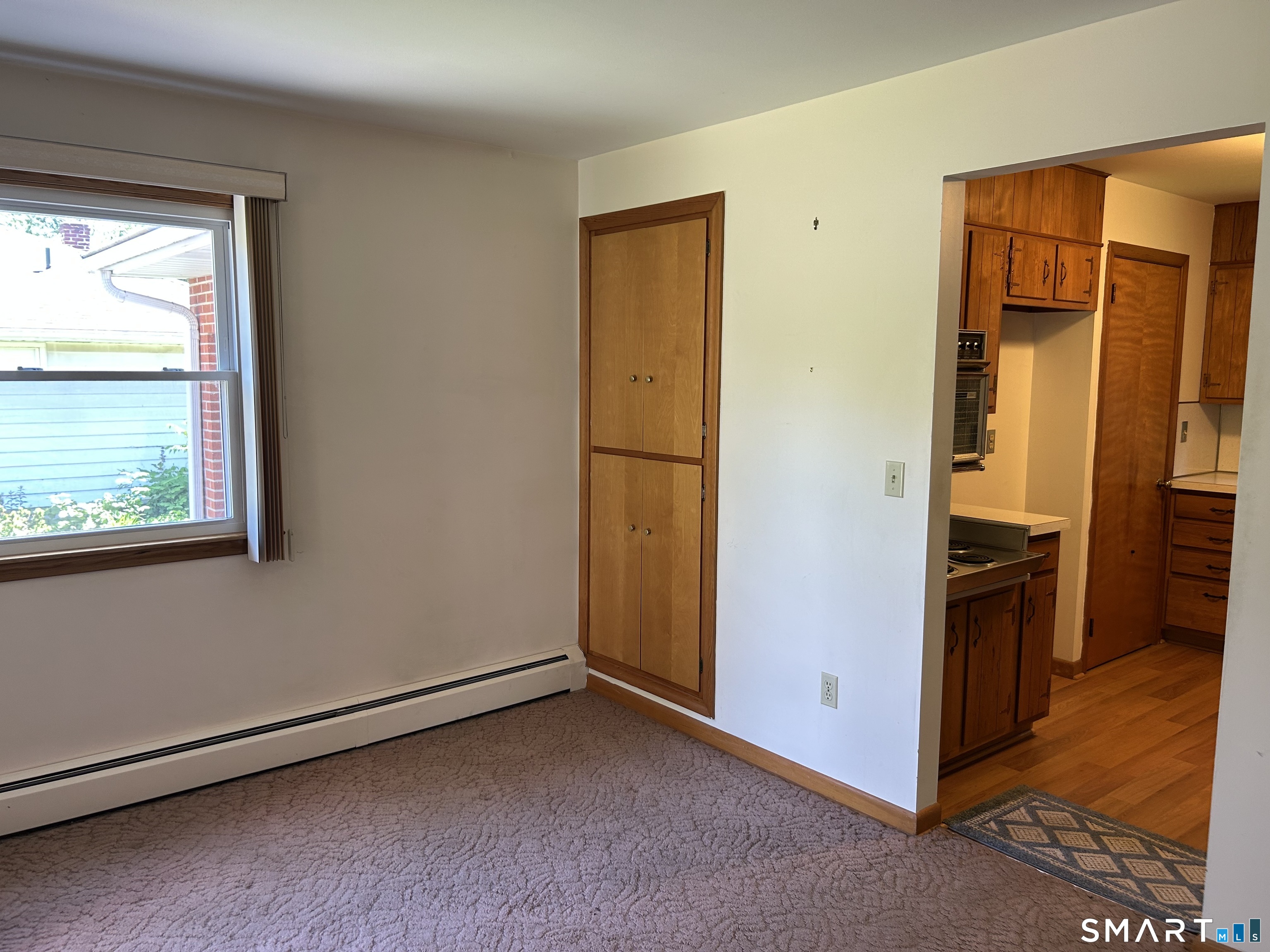 13 Walnut Lane Wallingford, CT 06492 - Photo 17 of 27 a view of a livingroom with an empty space and a window