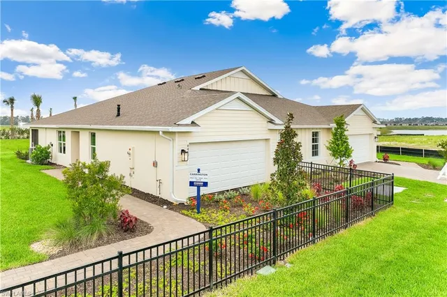 a view of a house with wooden fence