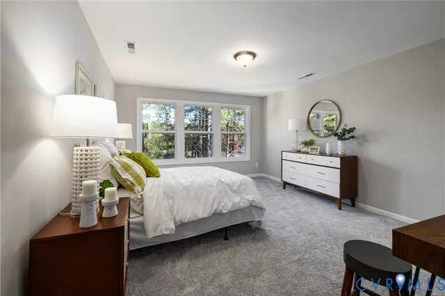 a bedroom with a bed chair and window