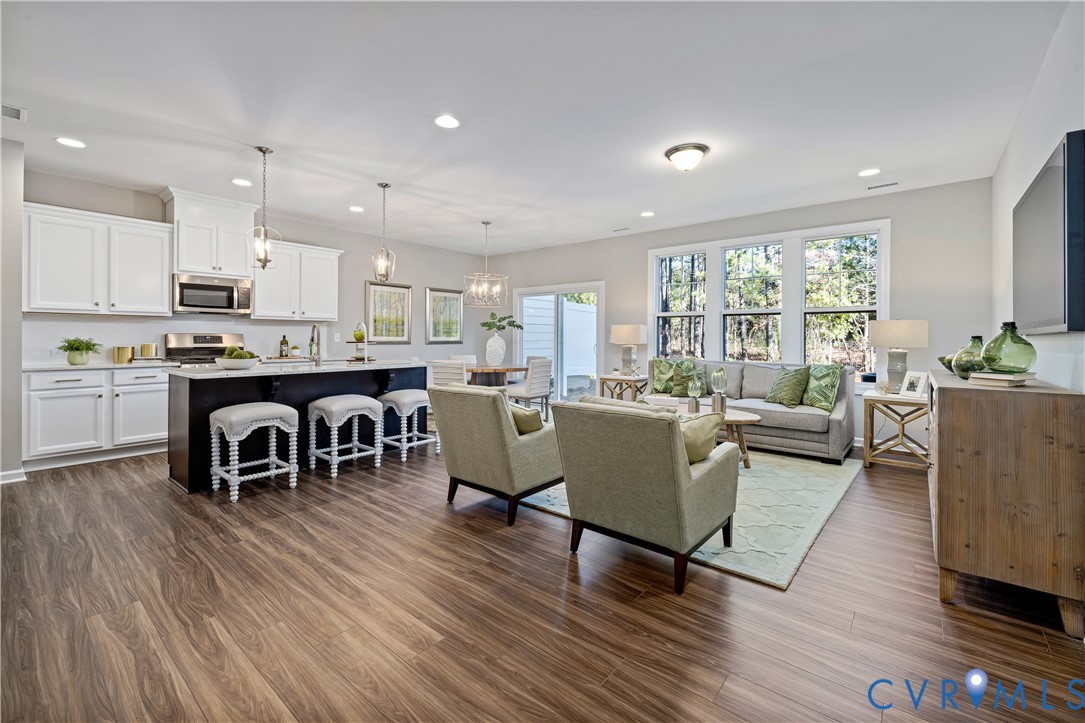 17348 Alana Drive Moseley, VA 23120 - Photo 5 of 36 a living room with furniture a wooden floor and kitchen view