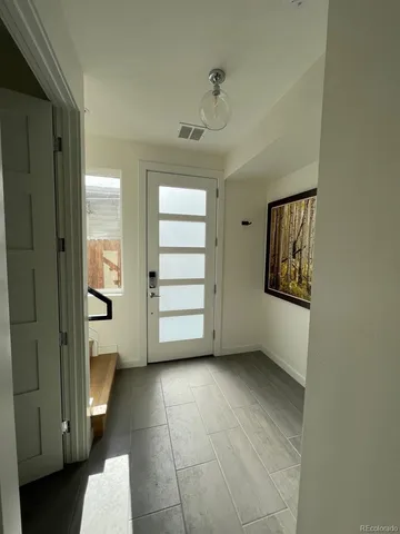 a view of an empty room and a bathroom