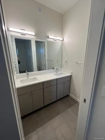 a bathroom with a double vanity sink and mirror