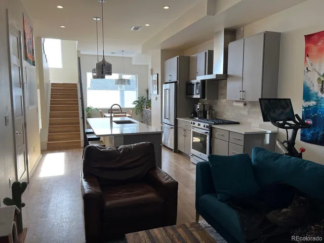 a kitchen with a refrigerator and a stove top oven