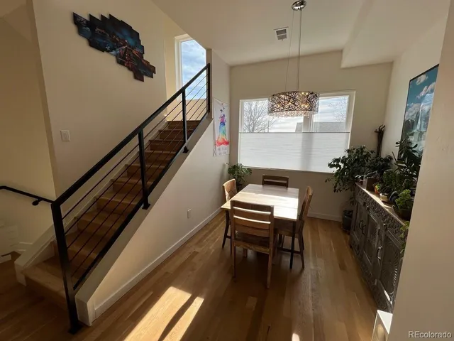 a room with table flowerpot and wooden floor