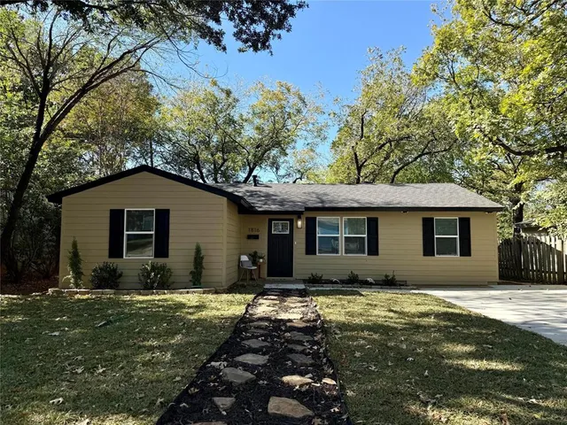 a front view of house with yard and trees