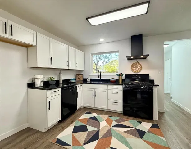 a kitchen with a sink stove and cabinets
