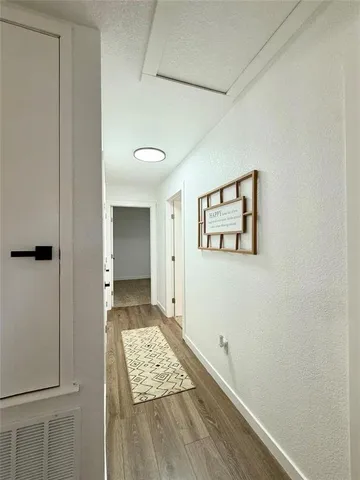 a view of room with window and wooden floor