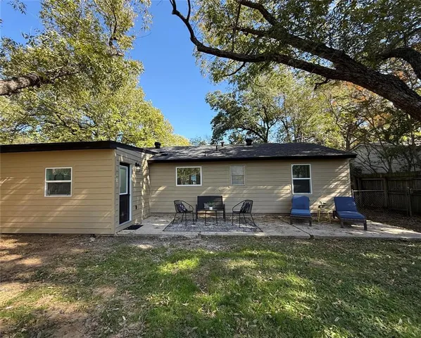 a backyard of a house with outdoor seating and yard