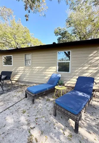 a backyard of a house with outdoor seating