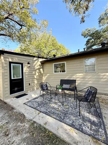 a backyard of a house with table and chairs