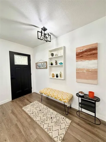 a bedroom with furniture and a wooden floor