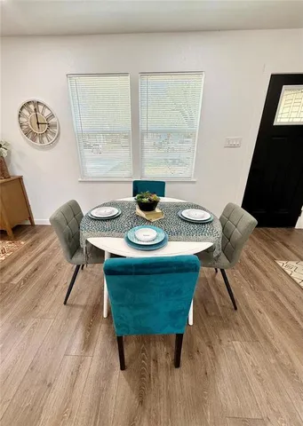 a dining room with furniture and wooden floor