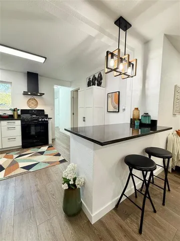 a living room with furniture and a kitchen view