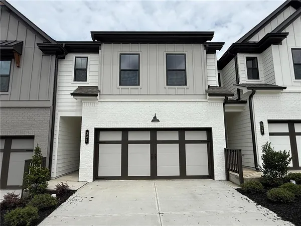 a front view of a house with large windows
