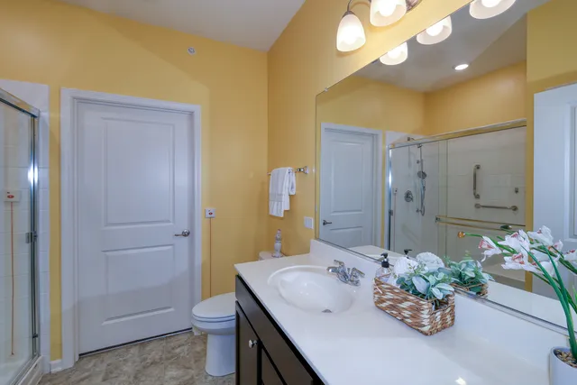 a bathroom with a sink a toilet and shower