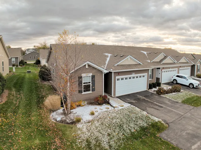 a view of a big house with wooden fence