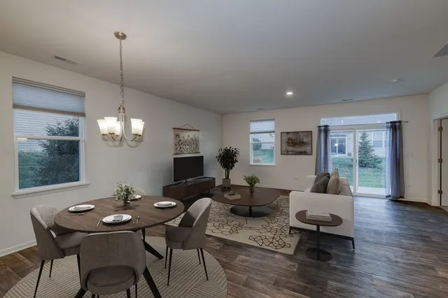 a living room with furniture and a chandelier