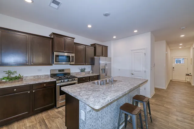 a kitchen with a stove a sink and a refrigerator