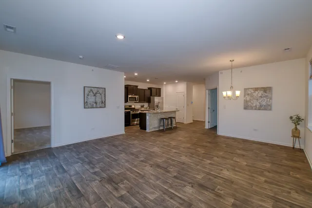a view of kitchen and hall with wooden floor