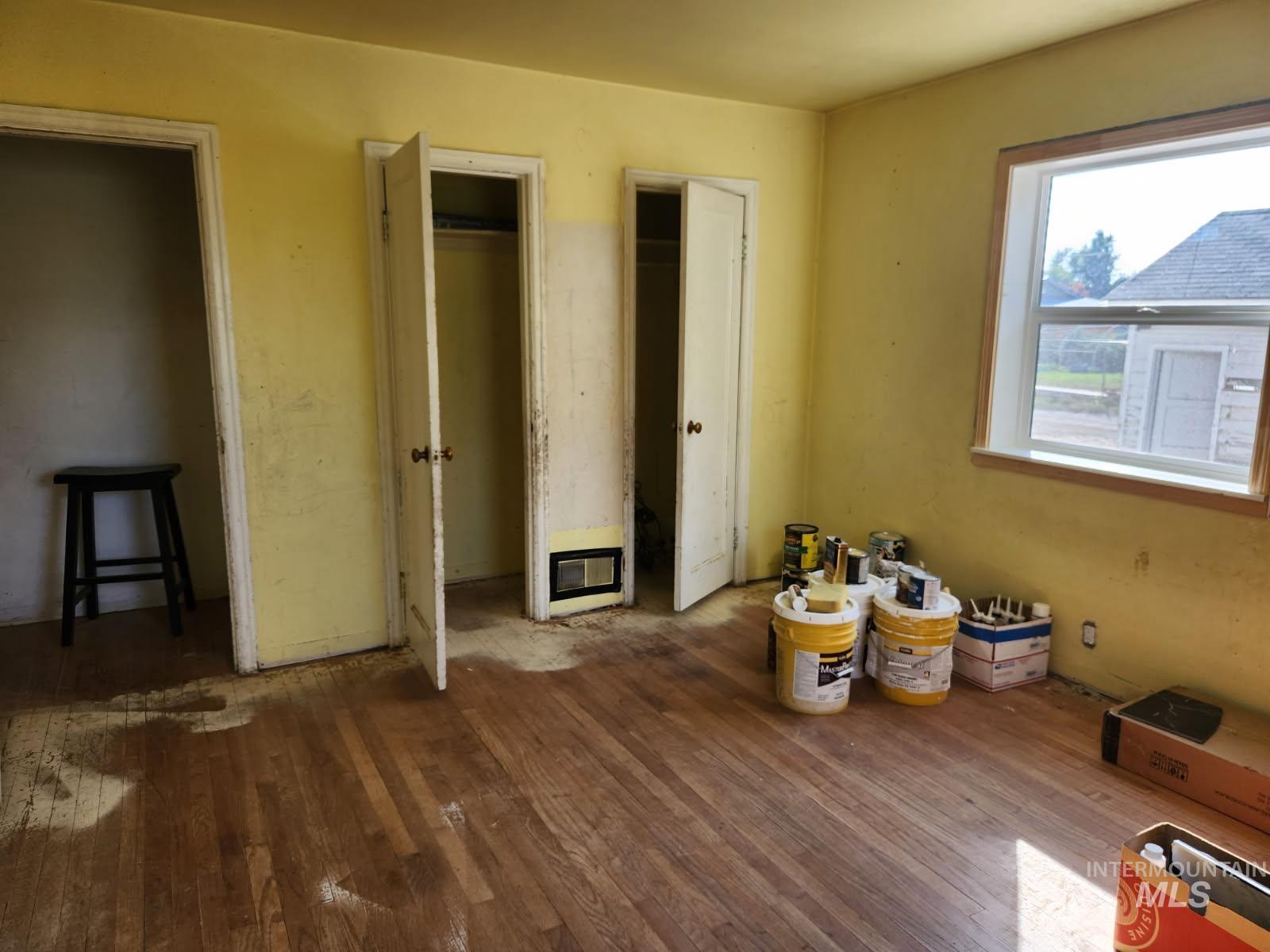 525 North 4th Street Nyssa, OR 97913 - Photo 8 of 17 Unfurnished bedroom with hardwood / wood-style flooring and two closets