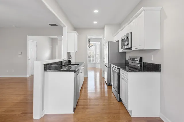 a kitchen with a refrigerator and a stove