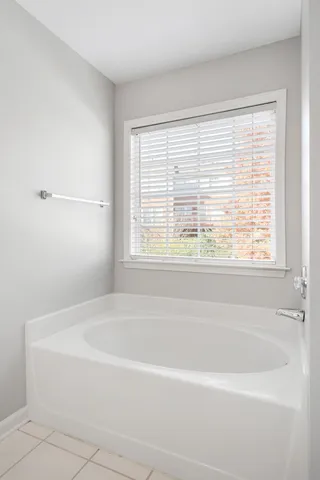 a white bath tub sitting next to a window