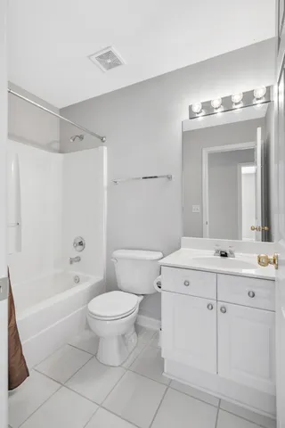 a bathroom with a double vanity sink mirror and toilet