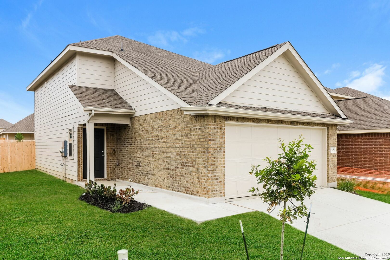 9318 Evening Shade Court San Antonio, TX 78211 - Photo 2 of 15 a front view of a house with a yard