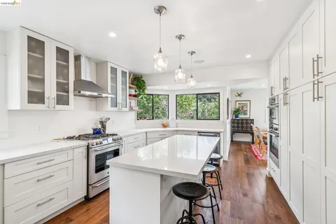 a kitchen with a stove a refrigerator and a sink