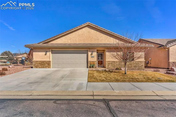 a view of a house with wooden fence