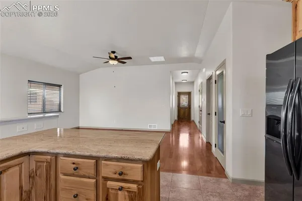 a view of a kitchen with a sink and a refrigerator