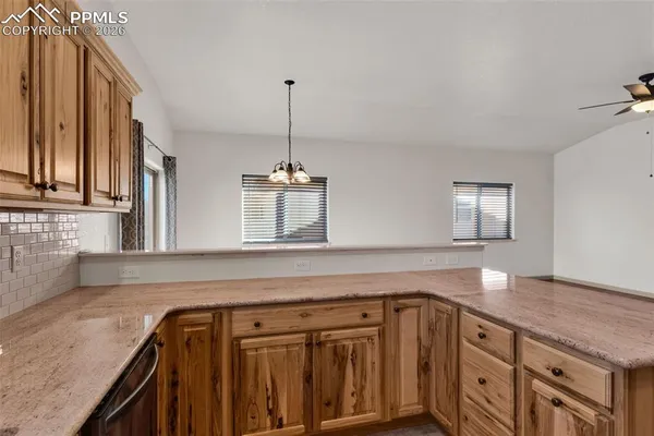 a kitchen with granite countertop a sink and cabinets